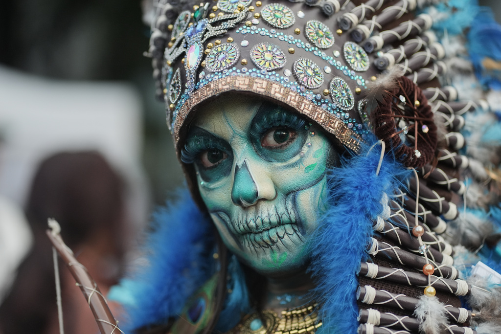 A woman takes part in the annual Day of the Dead Catrina parade in Mexico City, Sunday, Oct. 26, 2025. (AP Photo/Claudia Rosel)