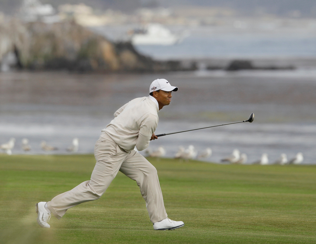 FILE - Tiger Woods watches his approach shot to the 18th green during the third round of the U.S. Open golf tournament Saturday, June 19, 2010, at the Pebble Beach Golf Links, in Pebble Beach, Calif. (AP Photo/Eric Risberg, File)