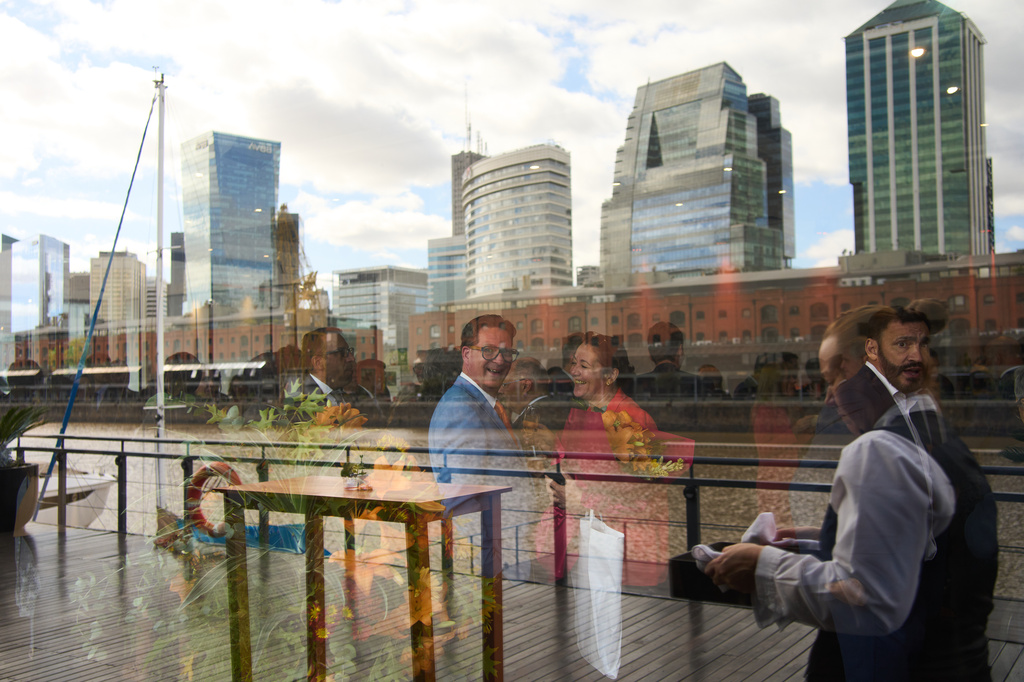 FILE - Guests are reflected in a window during a ceremony organized by the Dutch embassy for King's Day in Buenos Aires, Argentina, Monday, April 27, 2026. (AP Photo/Rodrigo Abd, File)