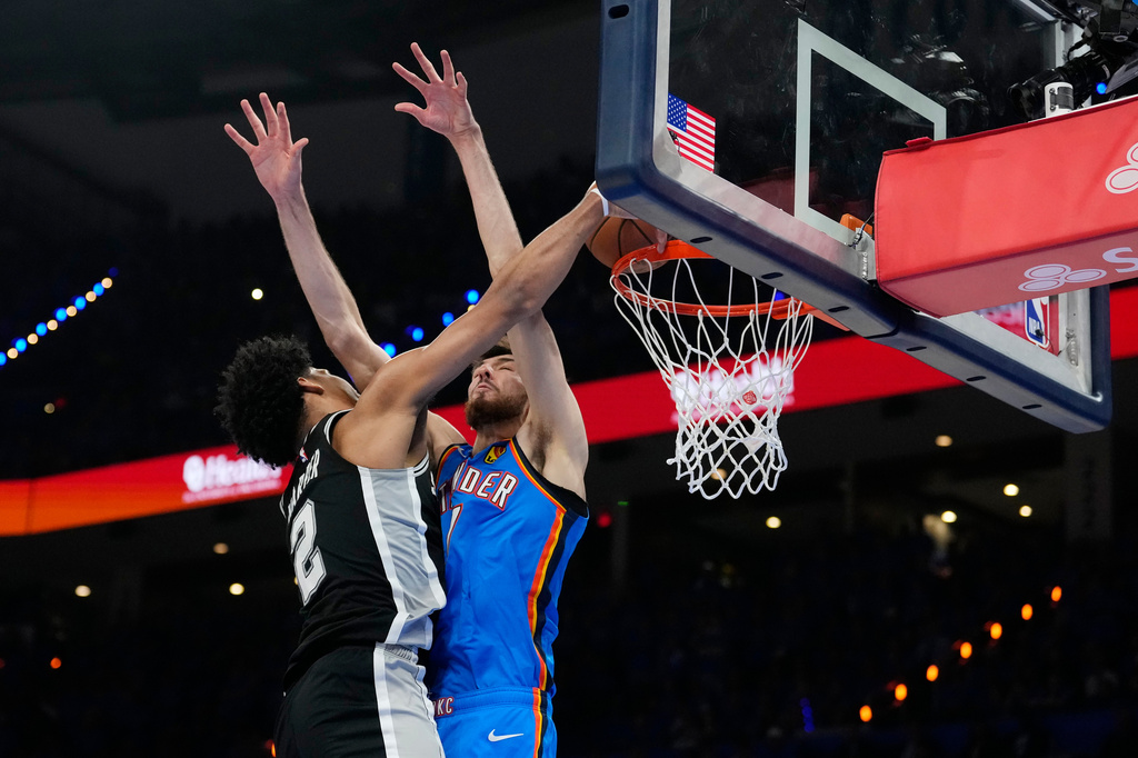 San Antonio Spurs guard Dylan Harper (2) goes up for a shot against Oklahoma City Thunder center Chet Holmgren during the second half of Game 7 of the Western Conference finals of the NBA basketball playoffs series Saturday, May 30, 2026, in Oklahoma City. (AP Photo/Tony Gutierrez)