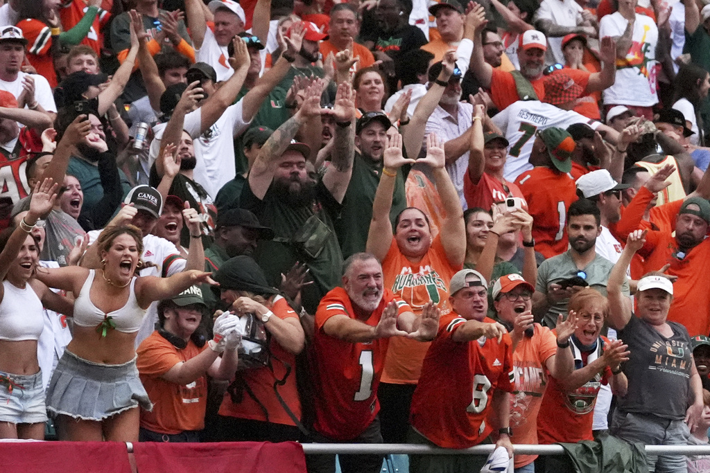 Miami fans celebrate a touchdown by running back Mark Fletcher Jr. during the first half of an NCAA college football game against South Florida, Saturday, Sept. 13, 2025, in Miami Gardens, Fla. (AP Photo/Rebecca Blackwell)