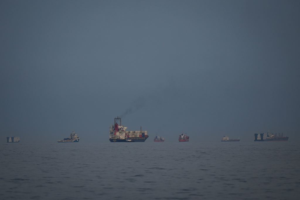 Oil tankers and cargo ships line up in the Strait of Hormuz as seen from Khor Fakkan, United Arab Emirates, Wednesday, March 11, 2026. (AP Photo/Altaf Qadri)