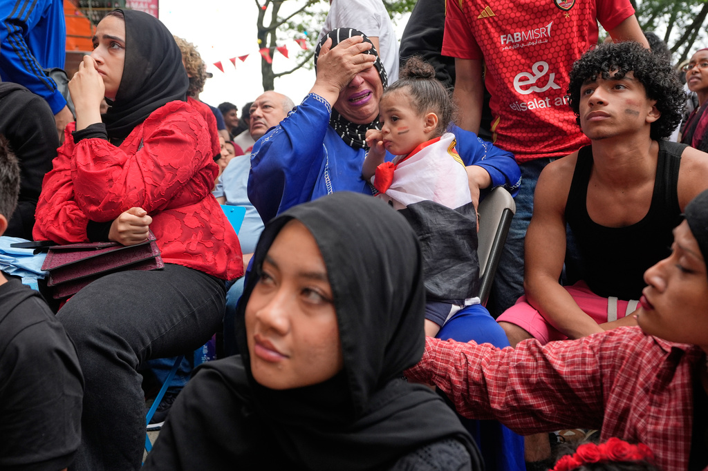 Egyptian fans, including Faten Moussa, center in blue, react towards the end of a World Cup soccer game against Argentina, in New York, Tuesday, July 7, 2026. (AP Photo/Seth Wenig)