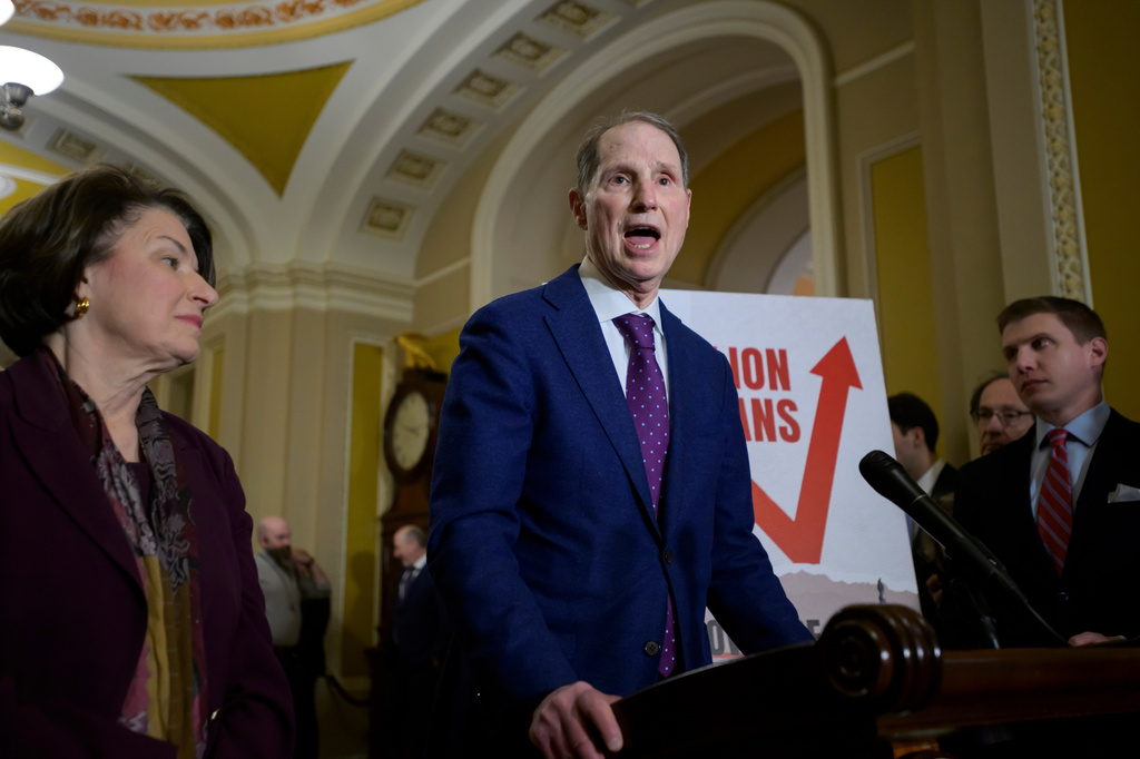 FILE - Sen. Ron Wyden, D-Ore., right, speaks as Sen. Amy Klobuchar, D-Minn., left, looks on during the Senate Democrat policy luncheon news conference at the Capitol, Dec. 2, 2025, in Washington. (AP Photo/Rod Lamkey, Jr., File)
