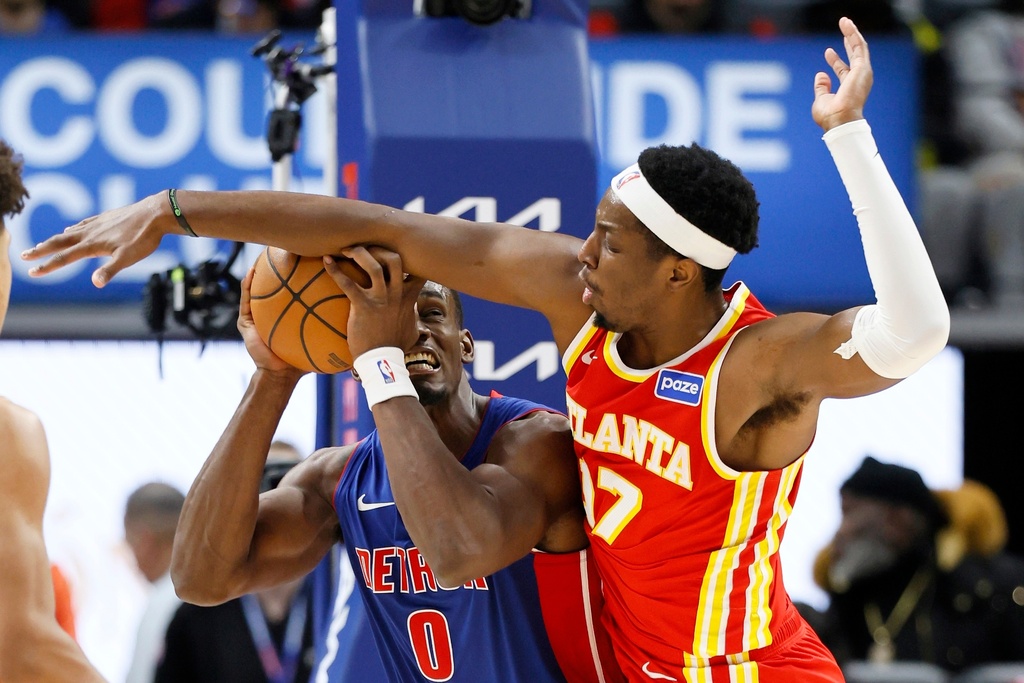Detroit Pistons center Jalen Duren (0) tries to get a shot off against Atlanta Hawks forward Onyeka Okongwu (17) during the first half of an NBA basketball game Friday, Dec. 12, 2025, in Detroit. (AP Photo/Duane Burleson)