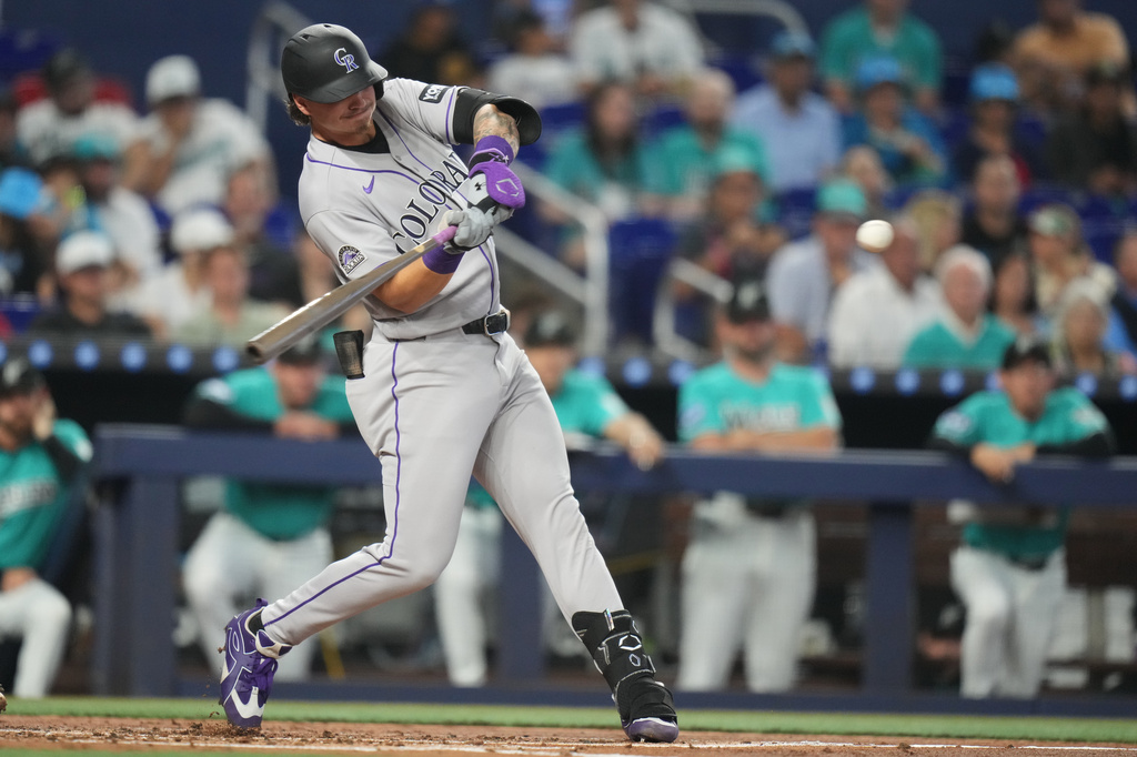 Colorado Rockies' Jordan Beck hits a RBI double to score three runs during the first inning of a baseball game against the Miami Marlins, Sunday, March 29, 2026, in Miami. (AP Photo/Lynne Sladky)