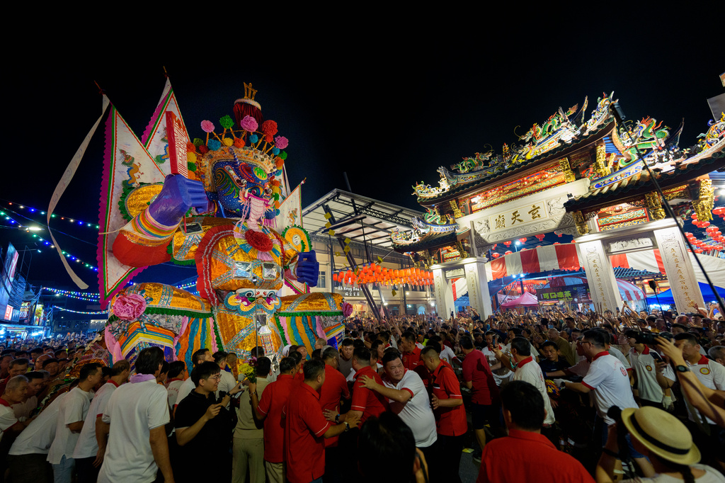Participants move a paper statue of Da Shi Ye, the Guardian God of Ghosts, through the streets during the Hungry Ghost Festival in Bukit Metajam, Malaysia, Saturday, Aug. 29, 2026. (AP Photo/Vincent Thian)