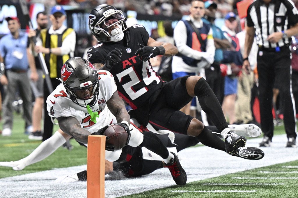 Tampa Bay Buccaneers running back Bucky Irving (7) runs in for a touchdown against Atlanta Falcons cornerback A.J. Terrell Jr. (24) during the second half of an NFL football game, Sunday, Sept. 7, 2025, in Atlanta. (AP Photo/Danny Karnik)