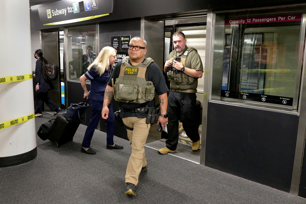 Federal agents step off the inter-terminal subway as they prepare to leave the George Bush Intercontinental Airport and transfer over to Hobby Airport Monday, March 23, 2026, in Houston. (AP Photo/Michael Wyke)