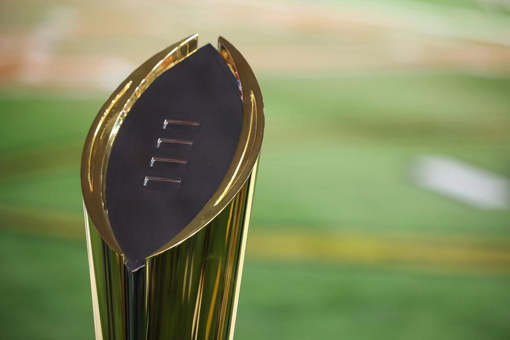 FILE - The College Football Playoff National Championship Trophy is shown before the Cotton Bowl College Football Playoff semifinal game between Texas and Ohio State, Friday, Jan. 10, 2025, in Arlington, Texas. (AP Photo/Gareth Patterson, File)