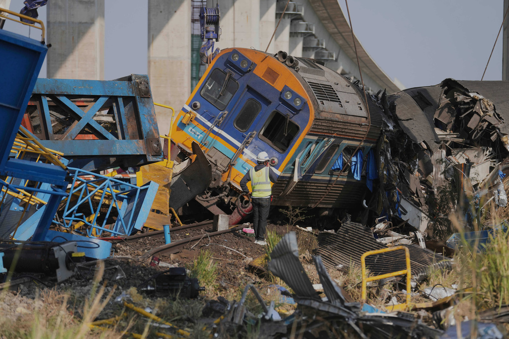 The wreckage after a construction crane fell into a passenger train in Nakhon Ratchasima province, Thailand, Wednesday, Jan.14, 2026. (AP Photo/Sakchai Lalit))