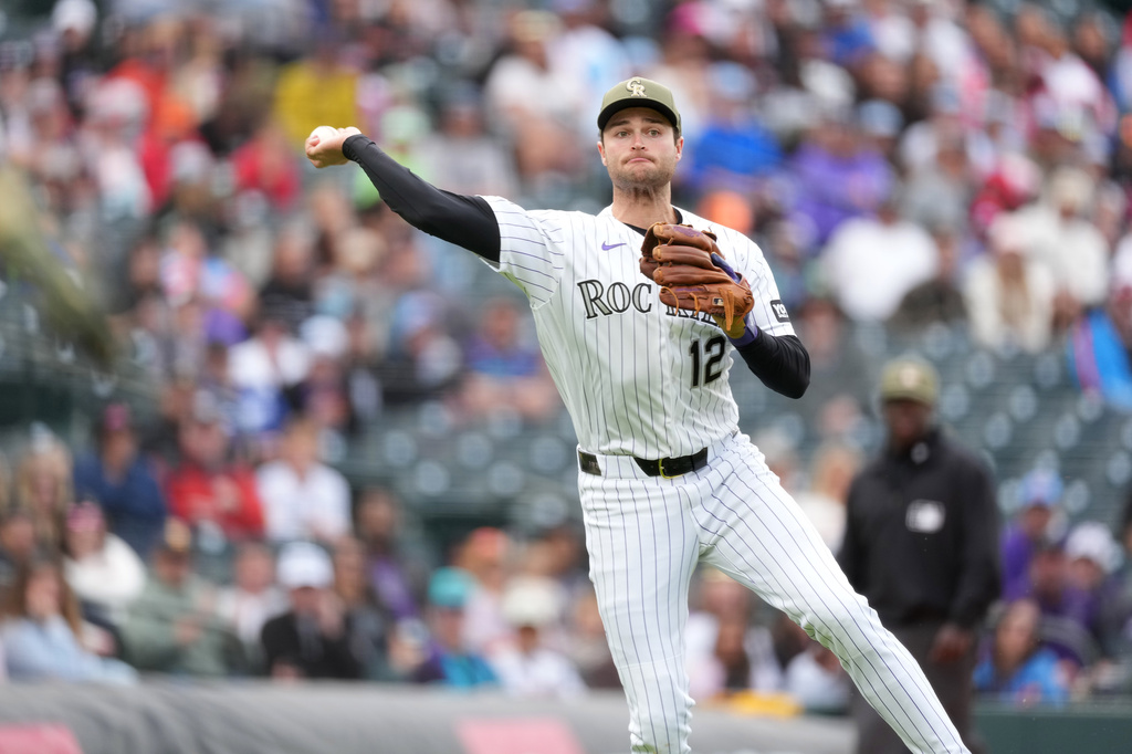 Colorado Rockies third baseman Kyle Karros throws the ball to first base after fielding an RBI single off the bat of Arizona Diamondbacks' Jose Fernandez in the fifth inning of a baseball game Sunday, May 17, 2026, in Denver. (AP Photo/David Zalubowski)