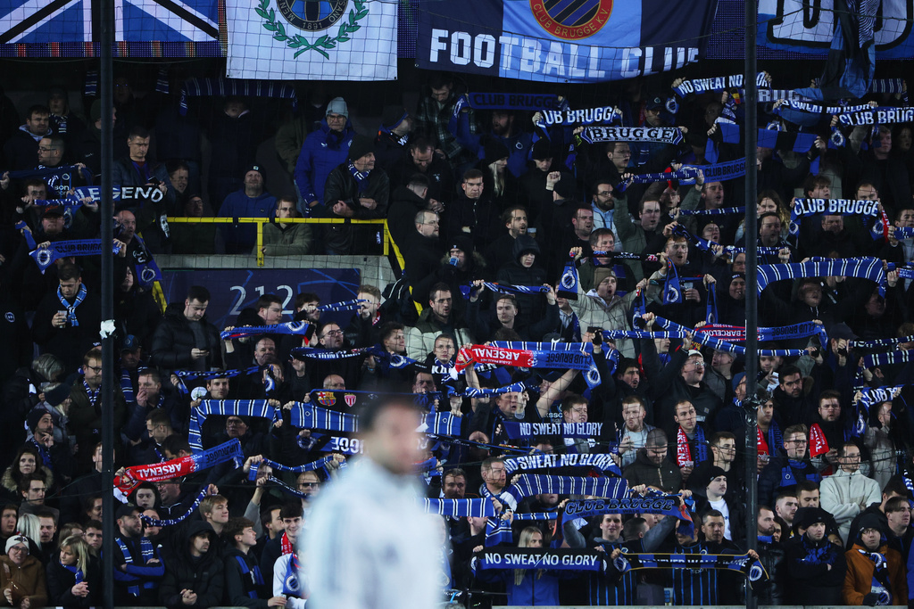 Fans hold up scarves to support their teams prior to the Champions League opening phase soccer match between Club Brugge and Arsenal in Bruges, Belgium, Wednesday, Dec. 10, 2025. (AP Photo/Omar Havana)