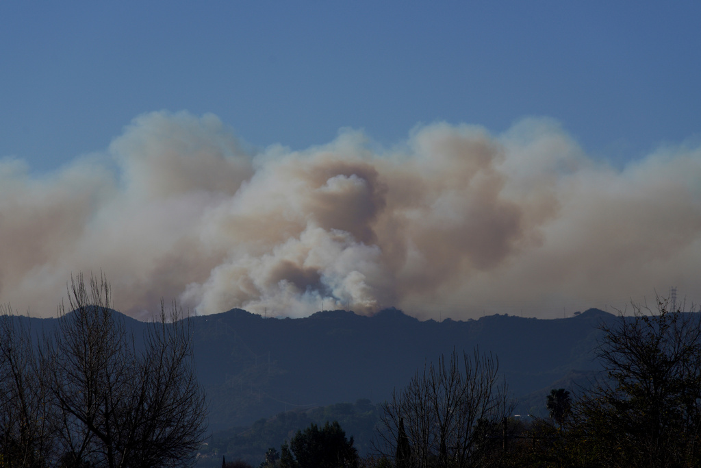 FILE - Smoke from the Palisades Fire rises over a ridge, Jan. 11, 2025, in Los Angeles. (AP Photo/Richard Vogel, File)