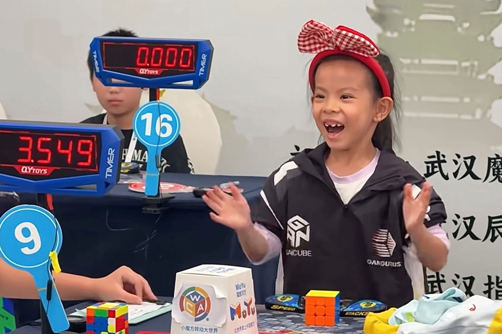 In this photo taken from video and released by YouTube@cuberootme, 6-year-old Lian Yunzhi reacts after solving a Rubik's cube at a World Cube Association-certified competition in the central Chinese city of Wuhan in central China's Hubei province on Sept. 13, 2026. (YouTube@cuberootme via AP)
