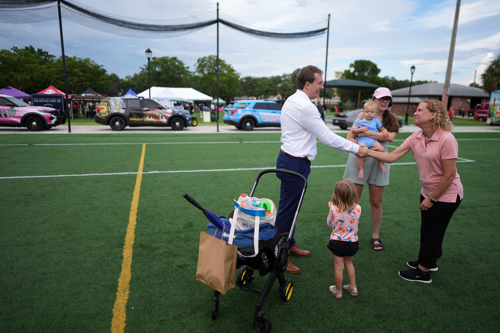 Rep. Debbie Wasserman Schultz, right, greets constituents at a National Night Out community event as she campaigns in Florida's 20th congressional district, Tuesday, Aug. 4, 2026, in Plantation, Fla. (AP Photo/Rebecca Blackwell)