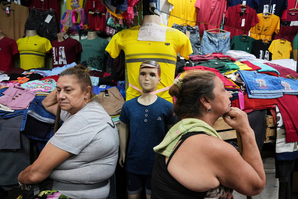 Vendors wait for customers at a market that primarily sells clothing imported from China in Asuncion, Paraguay, Saturday, Jan. 31, 2026. (AP Photo/Jorge Saenz)