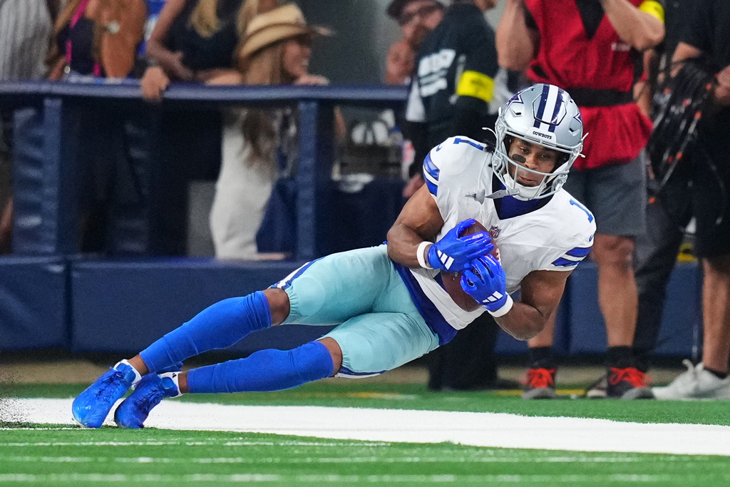Dallas Cowboys wide receiver Jalen Tolbert catches a long pass along the sideline in overtime of an NFL football game against the Green Bay Packers Sunday, Sept. 28, 2025, in Arlington, Texas. (AP Photo/Julio Cortez)