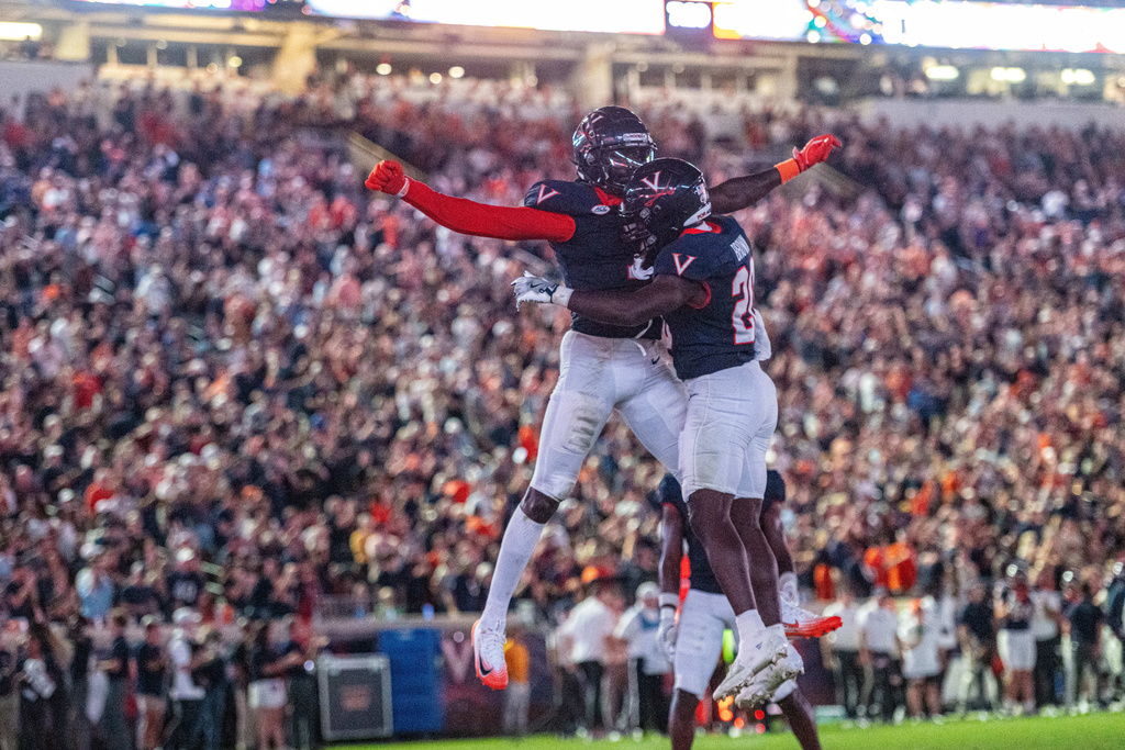 Virginia running back Xavier Brown (20) Virginia wide receiver Andre Greene Jr. (2) celebrate after a touchdown during the second half of an NCAA college football game, Friday, Sept. 26 2025, in Charlottesville, Va. (AP Photo/Robert Simmons)