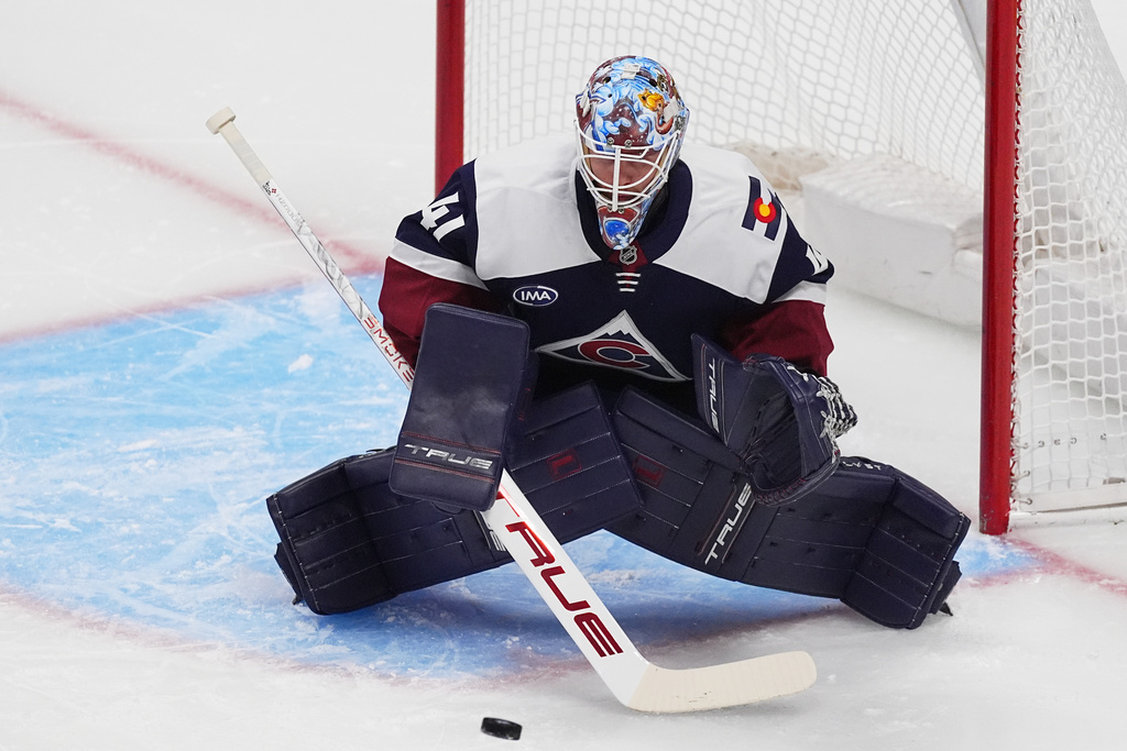 Colorado Avalanche goaltender Scott Wedgewood stops a shot in the first period of an NHL hockey game against the Winnipeg Jets, Friday, Dec. 19, 2025, in Denver. (AP Photo/David Zalubowski)