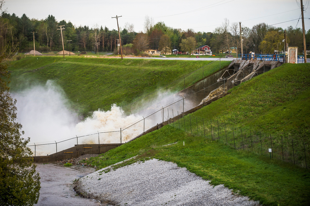 FILE - Water rushes through the Edenville Dam, May 19, 2020, in Edenville, Mich. (Katy Kildee/Midland Daily News via AP, File)