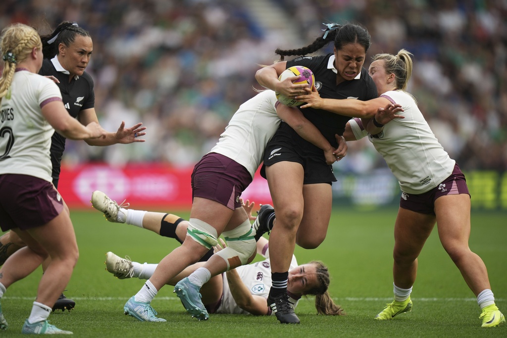 New Zealand's Logo-I-Pulotu Lemapu-Atai'i Sylvia Brunt, second from right, is tackled by Ireland's Edel McMahon, centre, and her teammate Aoife Wafer during Women's Rugby World Cup 2025 Pool C match between New Zealand and Ireland, at the Brighton and Hove Albion Stadium, in Sunday, Sept. 7, 2025. (AP Photo/Alastair Grant)
