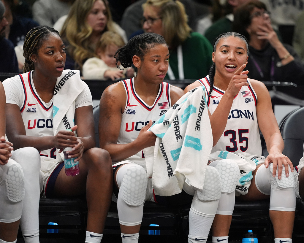 UConn's Azzi Fudd, right, talks with teammates KK Arnold, center, and Sarah Strong, left, during the second half of an NCAA college basketball game against Iowa Saturday, Dec. 20, 2025, in New York. (AP Photo/Frank Franklin II)