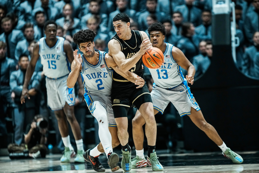 Duke's Cayden Boozer (2) fights for the ball against Army's Joshua Eli during the second half of an NCAA college basketball game, Tuesday, Nov. 11, 2025, in West Point. N.Y. (AP Photo/Eduardo Munoz Alvarez)