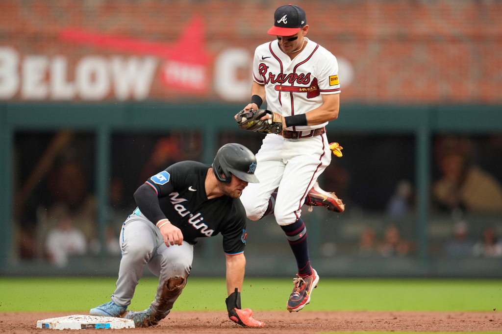 Atlanta Braves left fielder Mauricio Dubón (14) makes the tag on Miami Marlins' Jakob Marsee (87) in the third inning of a baseball game, Wednesday, Aug. 5, 2026, in Atlanta. (AP Photo/Mike Stewart)