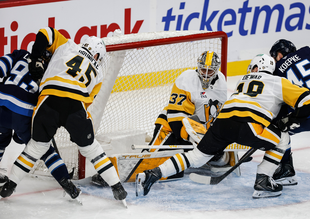 Winnipeg Jets' Brad Lambert (93) scores on Pittsburgh Penguins goaltender Arturs Silovs (37) as Harrison Brunicke (45) and Connor Dewar (19) defend during the first period of an NHL hockey game, Saturday, Nov. 1, 2025, in Winnipeg, Manitoba. (John Woods/The Canadian Press via AP)