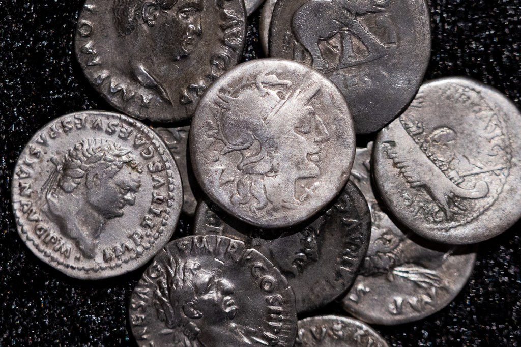 Roman coins, including the one coin, centre, dating from 148 B.C., when Rome was still a republic without an emperor, are on display at the LVR State Museum, in Bonn, Germany, Tuesday Sept. 22, 2026. (Rolf Vennenbernd/dpa via AP)