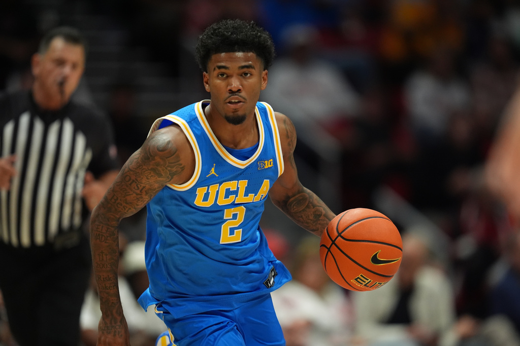 UCLA guard Donovan Dent (2) dribbles during the second half of an NCAA college basketball exhibition game against San Diego State Friday, Oct. 17, 2025, in San Diego. (AP Photo/Gregory Bull)