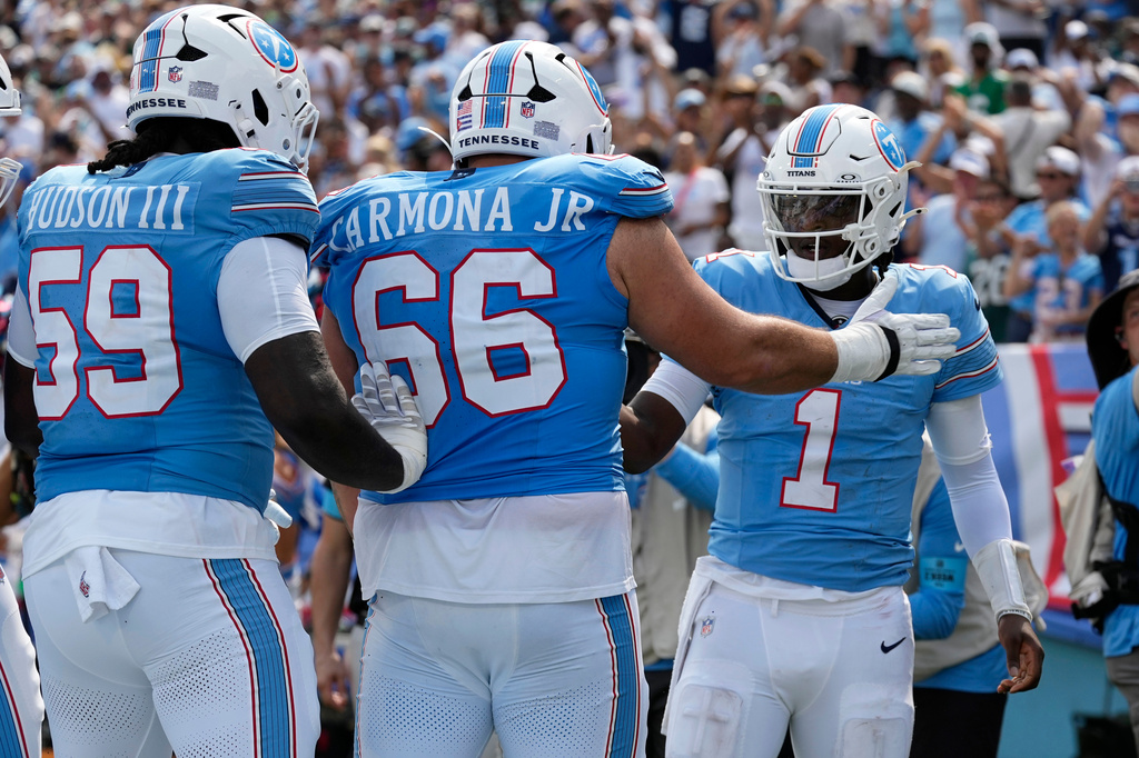 Tennessee Titans quarterback Cam Ward (1) celebrates with teammates after scoring a touchdown during the second half of an NFL football game against the Philadelphia Eagles, Sunday, Sept. 20, 2026, in Nashville, Tenn.(AP Photo/George Walker IV)