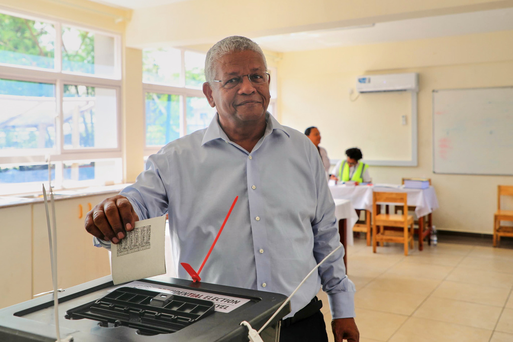President Wavel Ramkalawan casts his vote in a runoff presidential election between him and opposition challenger Patrick Herminie, at Belonie Secondary School in St Louis, Mahe, Seychelles, Saturday, Oct. 11, 2025. (AP Photo/Emilie Chetty)