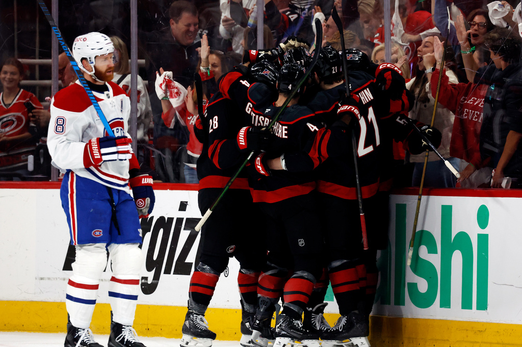 Carolina Hurricanes players celebrate after a goal by Eric Robinson as Montreal Canadiens' Mike Matheson (8) skates by during the first period in Game 5 of the Eastern Conference finals NHL hockey Stanley Cup playoff series in Raleigh, N.C., Friday, May 29, 2026. (AP Photo/Karl DeBlaker)