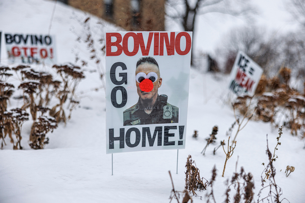 A poster reading "Bovino Go Home," featuring an altered image of U.S. Border Patrol Cmdr. Gregory Bovino, is displayed in the snow outside a home on Wednesday, Jan. 21, 2026, in Minneapolis. (Kerem Yücel/Minnesota Public Radio via AP)