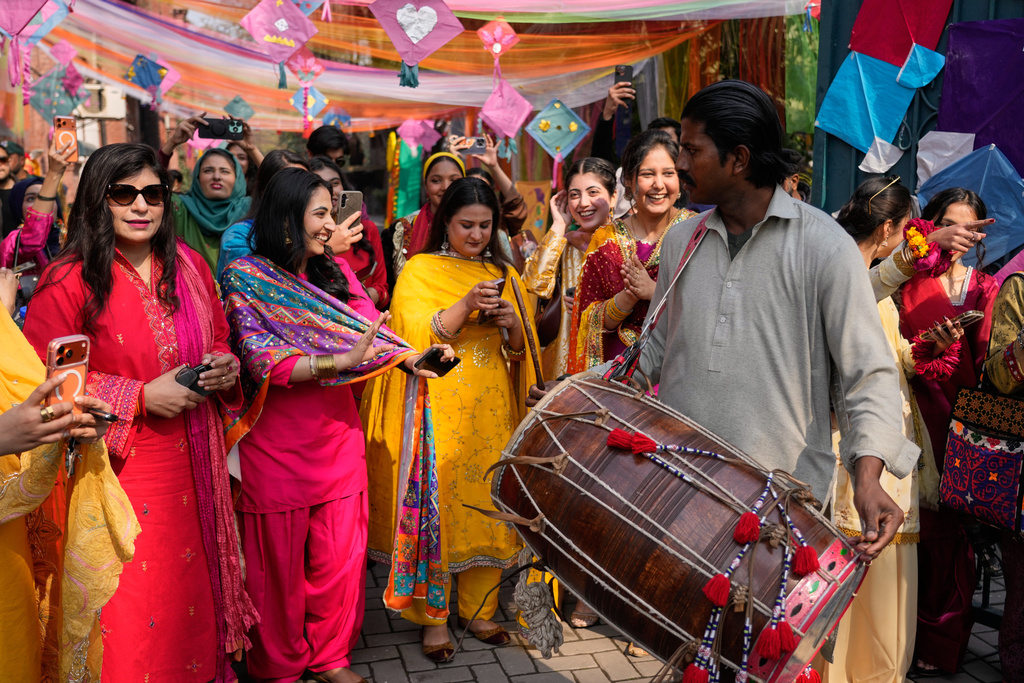 Students dance on traditional drum beat during a gathering to celebrate three-day kite flying festival 'Basant' at their university campus, in Lahore, Pakistan, Friday, Feb. 6, 2026. (AP Photo/K.M. Chaudary)