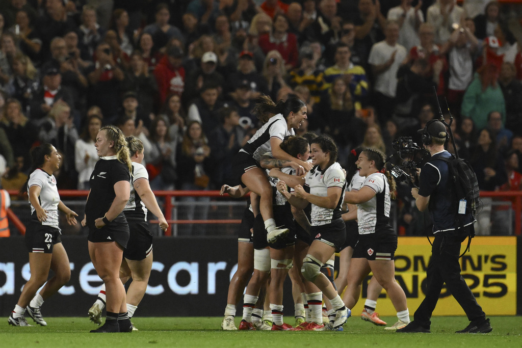 Canada's team members celebrate as they won the Women's Rugby World Cup 2025 semifinal match between New Zealand and Canada in Bristol, England, Friday, Sept. 19, 2025.(AP Photo/Anthony Upton)