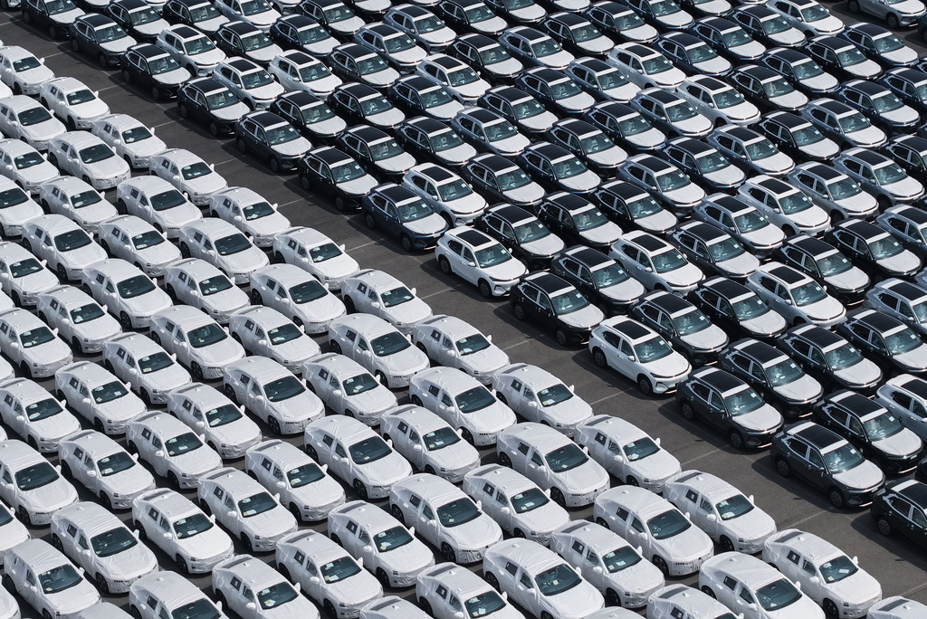 New vehicles wait to be shipped to overseas markets at a port in Shanghai, China, Tuesday, July 14, 2026. (Chinatopix via AP)