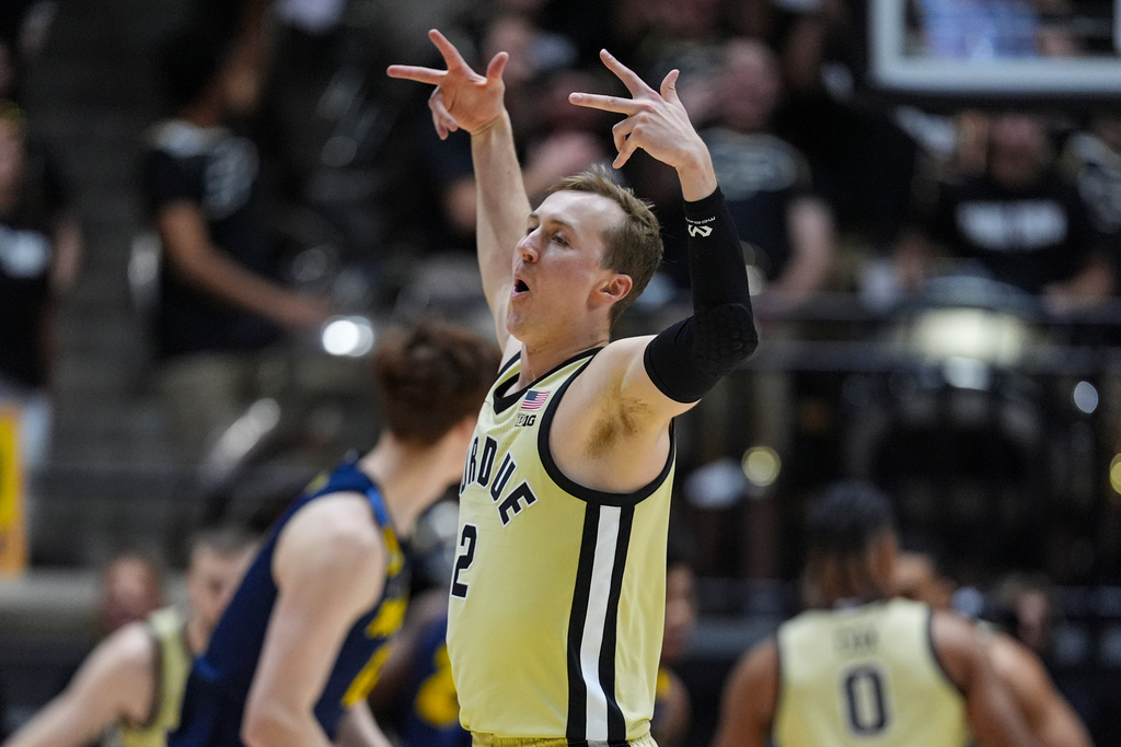 Purdue guard Fletcher Loyer (2) celebrates after a three-point basket against the Marquette during the first half of an NCAA college basketball game in West Lafayette, Ind., Saturday, Dec. 13, 2025. (AP Photo/Michael Conroy)