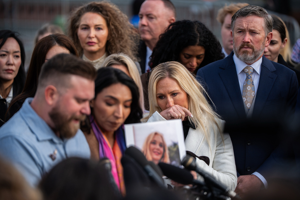 Rep. Marjorie Taylor Greene, R-Ga., second from right, and Rep. Thomas Massie, R-Ky., right, react during a news conference on the Epstein Files Transparency Act, Tuesday, Nov. 18, 2025, outside the U.S. Capitol in Washington. (AP Photo/Julia Demaree Nikhinson)