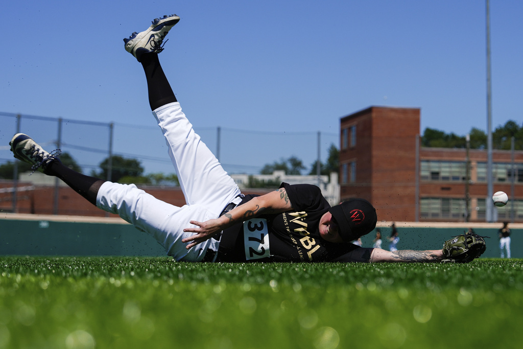 Carey Rodriguez falls while trying to catch the ball during the first day of tryouts for the Women's Professional Baseball League, Friday, Aug 22, 2025, at the Washington Nationals Youth Baseball Academy in Washington. (AP Photo/Julia Demaree Nikhinson)