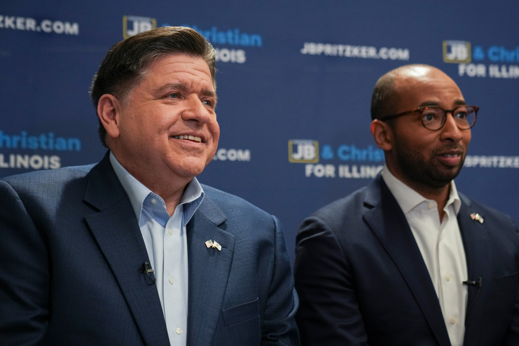 Illinois Gov. JB Pritzker, left, and running mate, candidate for lieutenant governor, speak during an interview, Wednesday, March 18, 2026, in Chicago. (AP Photo/Erin Hooley)