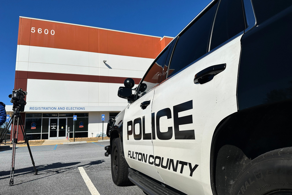 Police vehicles are seen outside the Fulton County elections hub in Union City, Ga., Wednesday, Jan. 28, 2026. (AP Photo/Emilie Megnien)