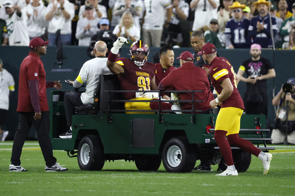 Washington Commanders defensive end Deatrich Wise (91) is taken off on a cart after being injured during the first half of an NFL football game against the Green Bay Packers Thursday, Sept. 11, 2025, in Green Bay, Wis. (AP Photo/Mike Roemer)