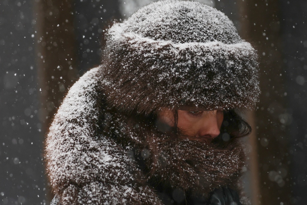 FILE - Pedestrians walk down Fifth Avenue during a winter storm Jan. 25, 2026, in New York. (AP Photo/Heather Khalifa, File)