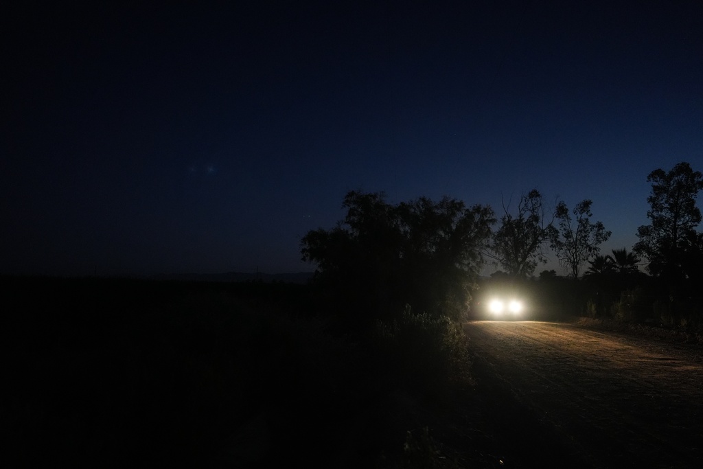 Researchers arrive at a sugarcane field at dawn to collect environmental data in Niland, Calif., Thursday, Sept. 11, 2025. (AP Photo/Jae C. Hong)