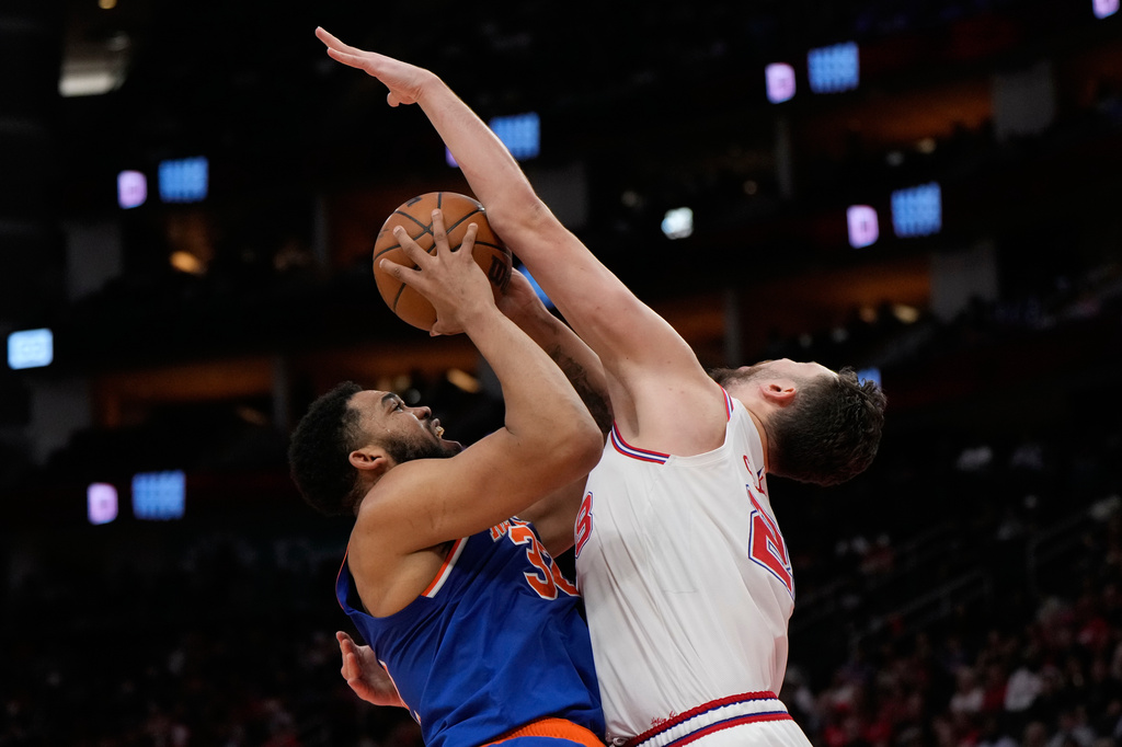 Houston Rockets center Alperen Sengun fouls New York Knicks center Karl-Anthony Towns (32) during the first half of an NBA basketball game in Houston, Tuesday, March 31, 2026. (AP Photo/Ashley Landis)