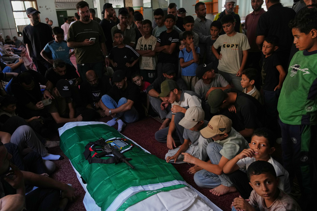 Palestinian mourners by the body of Muhammad Yazouri, who was killed in an Israeli airstrike Thursday night, during his funeral in Khan Younis, southern Gaza Strip, Friday, Sept.11, 2026. (AP Photo/Jehad Alshrafi)