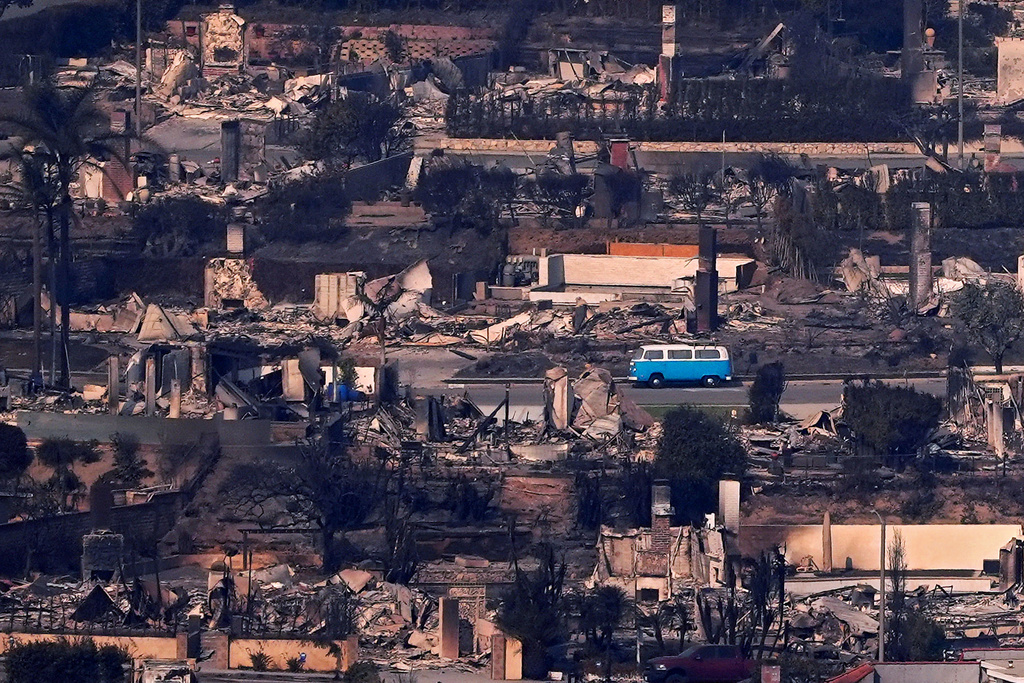FILE - A bus sits among burned out homes, Jan. 9, 2025, in Malibu, Calif. (AP Photo/Mark J. Terrill, File)